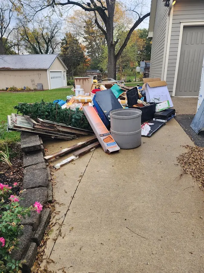 Dumpster being loaded with debris for Estate Cleanout Dumpster Rental in East Cleveland